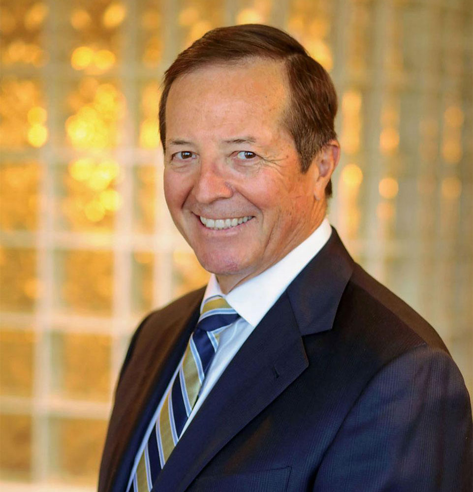headshot of doctor smiling brightly within the dental center
