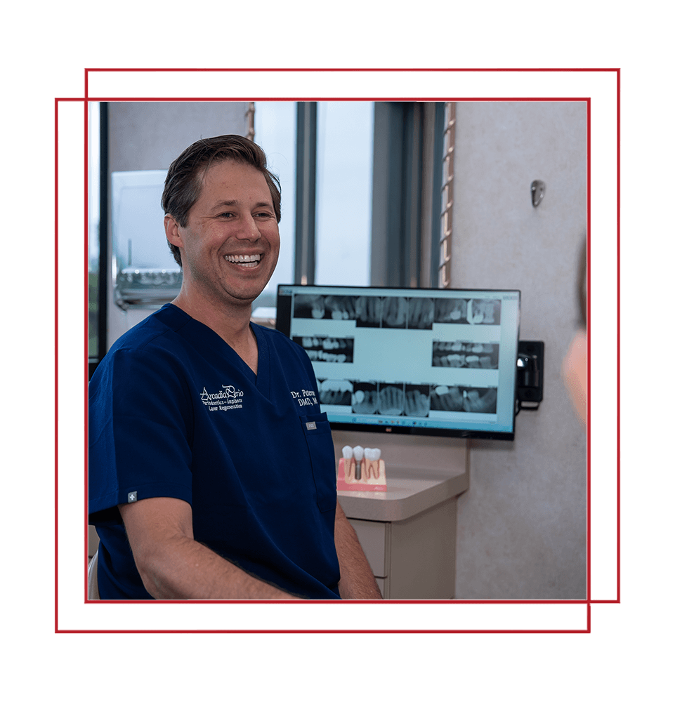 doctor smiling brightly while going over dental procedure information