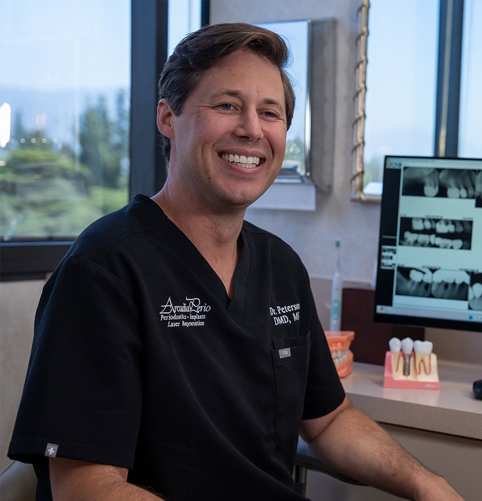 doctors smiling going over dental procedure information with patient