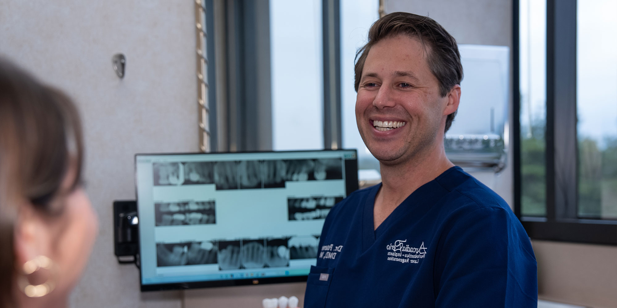 headshot of doctor smiling brightly after patient dental procedure information